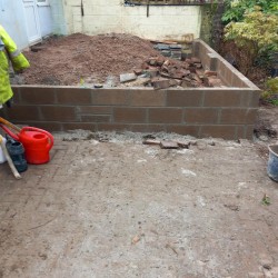 Customer had old slippery decking. We demolished it and built retaining wall and laid new patio slabs.