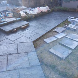 Customer had old slippery decking. We demolished it and built retaining wall and laid new patio slabs.